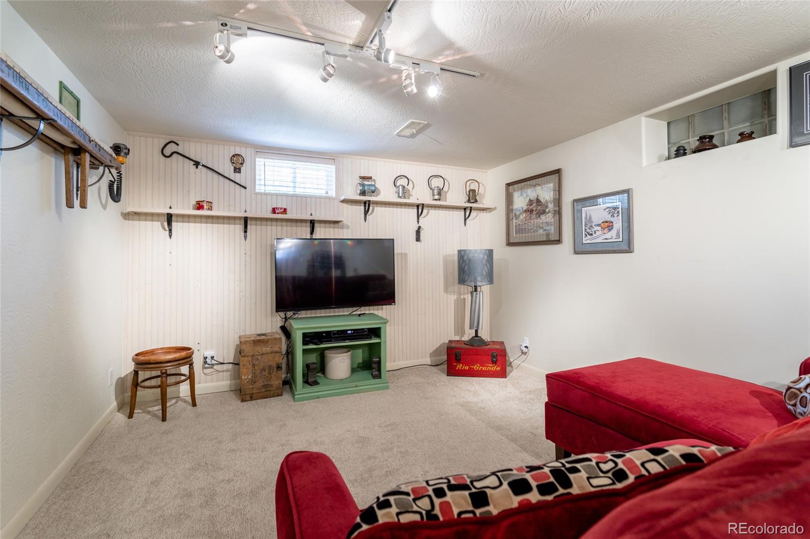 4530 South Inca Street Englewood, CO 80110 - Photo 23 of 37 a bedroom with furniture and a flat screen tv