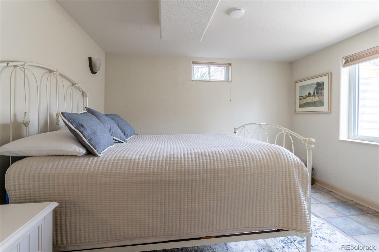 4530 South Inca Street Englewood, CO 80110 - Photo 26 of 37 a bedroom with a bed and a window