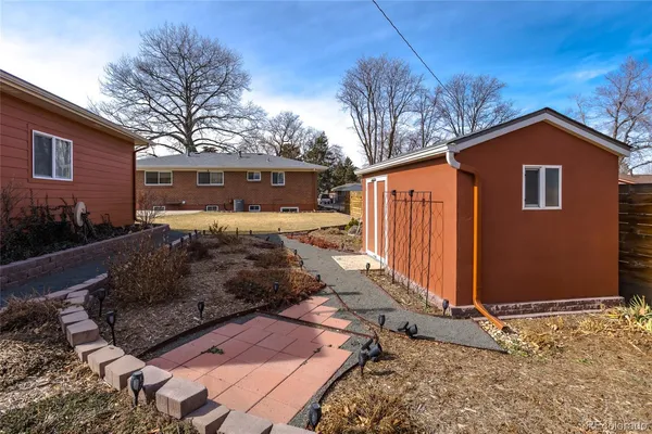 a view of a house with a yard covered in snow