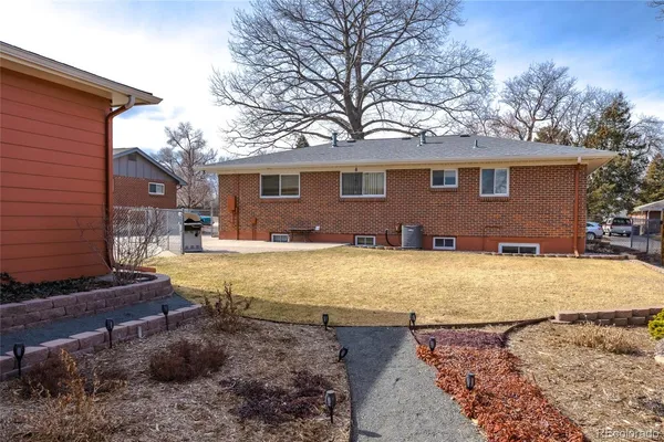 a view of a house with backyard space and balcony