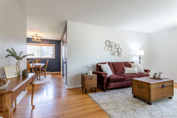 a living room with furniture and wooden floor