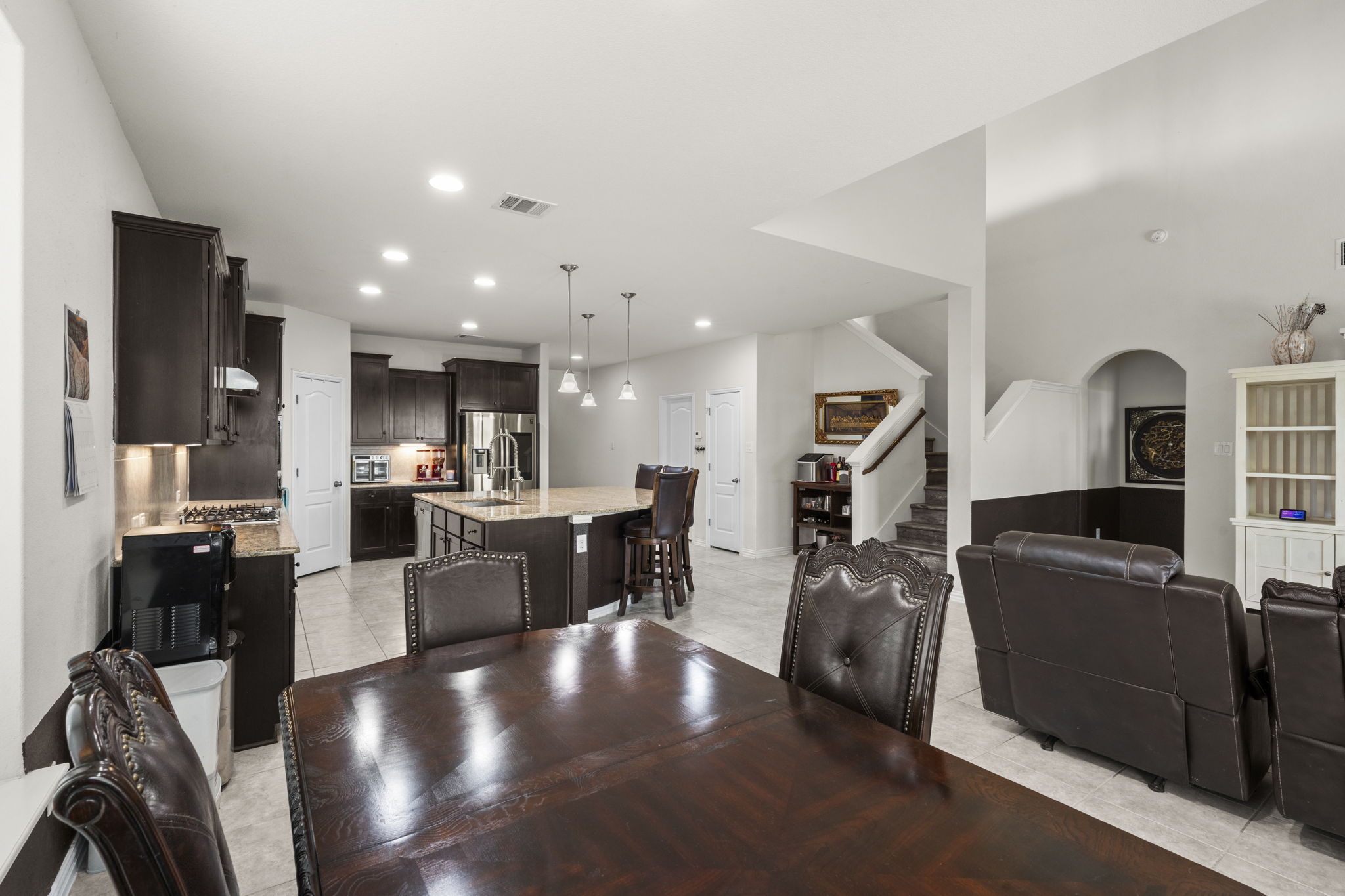 373 Rough Bark Street Buda, TX 78610 - Photo 8 of 39 An open concept design seamlessly connects a spacious kitchen with a dining area, perfect for entertaining.