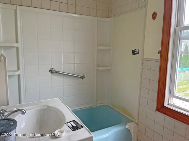 a bathroom with a tub and shower