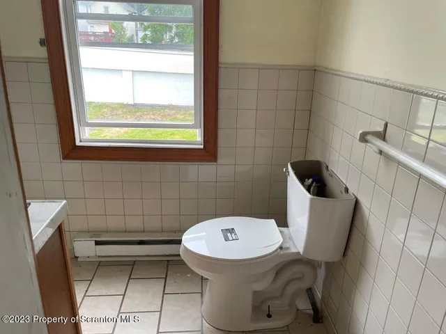 a bathroom with a toilet and a sink