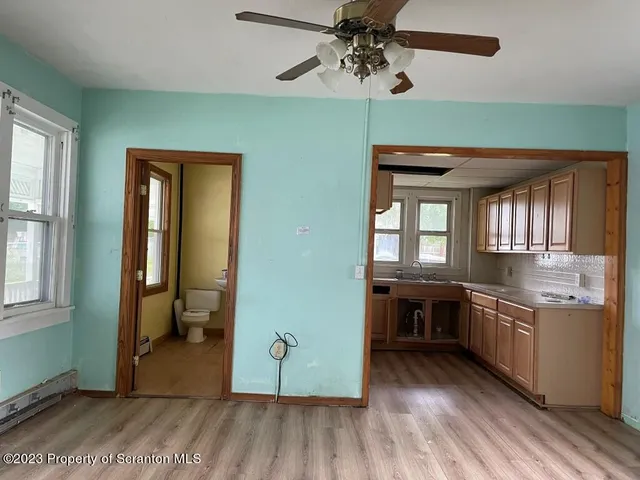 a view of a kitchen with a sink cabinets and wooden floor