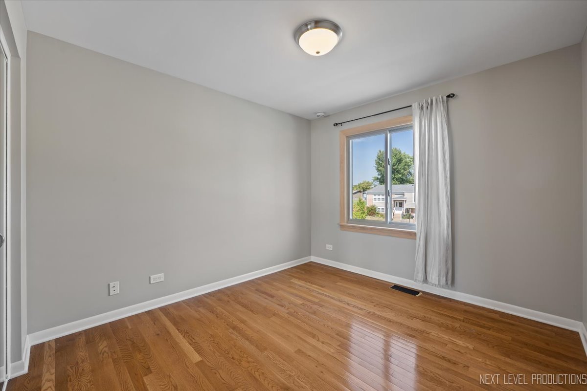 3011 Scenicwood Lane Woodridge, IL 60517 - Photo 14 of 21 an empty room with wooden floor and window