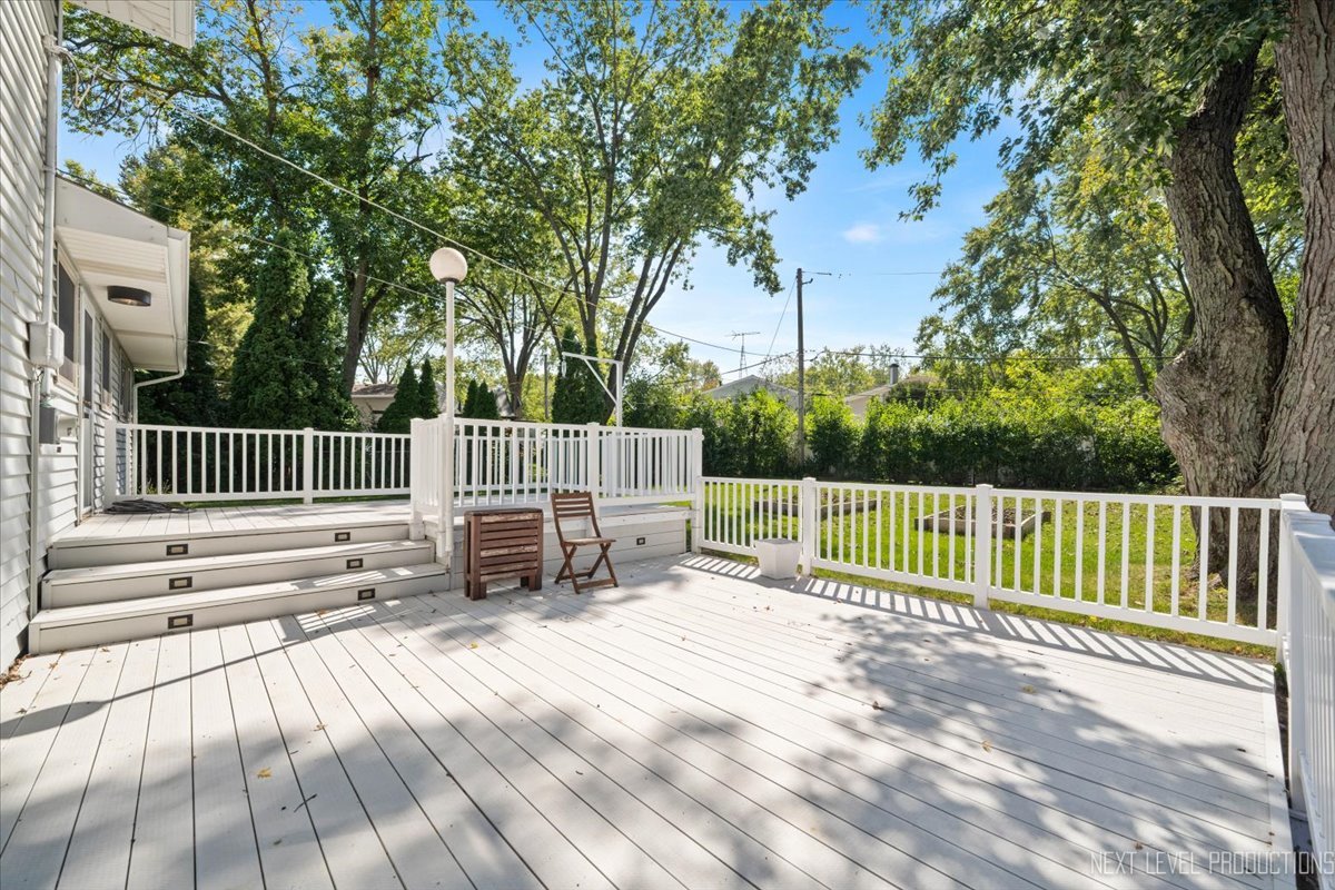 3011 Scenicwood Lane Woodridge, IL 60517 - Photo 17 of 21 a view of deck with a white roof and wooden fence