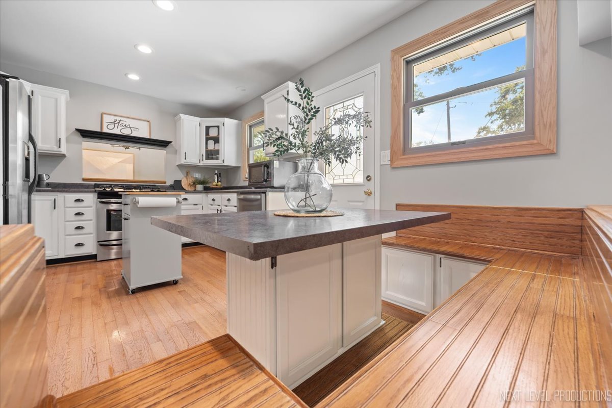 3011 Scenicwood Lane Woodridge, IL 60517 - Photo 7 of 21 a kitchen with stainless steel appliances granite countertop a stove a sink dishwasher and a refrigerator with wooden floor