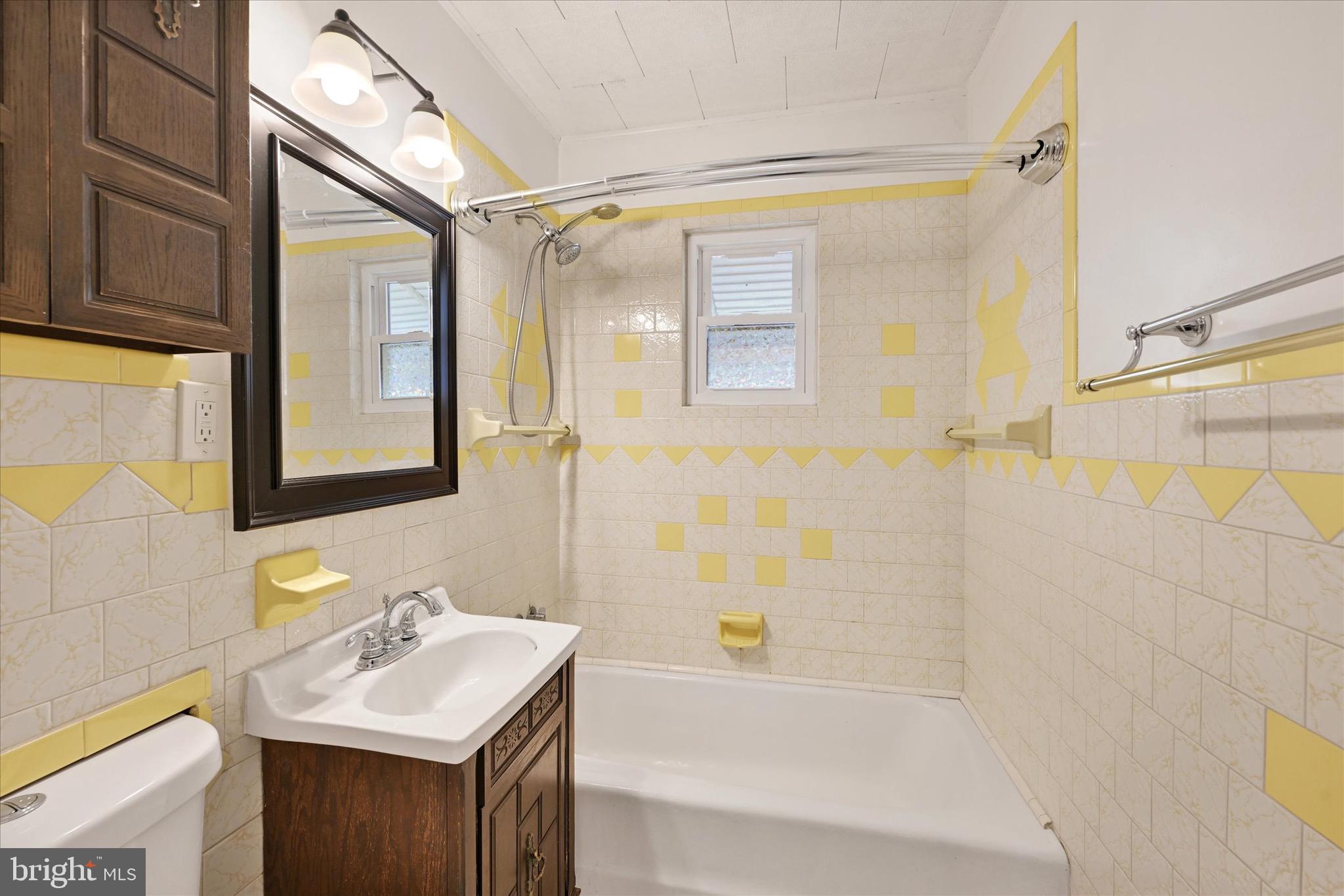 563 Compass Road East Baltimore, MD 21220 - Photo 10 of 23 a bathroom with a sink vanity granite tub shower and a mirror