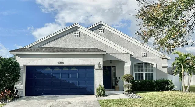 a front view of a house with a yard and garage