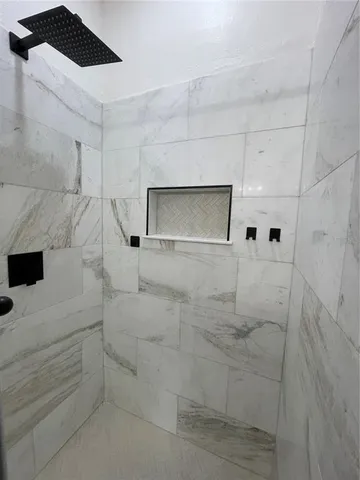 a bathroom with a bathtub and shower