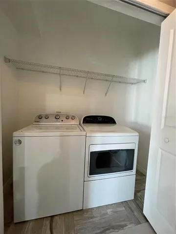 a bathroom with a toilet sink vanity and mirror