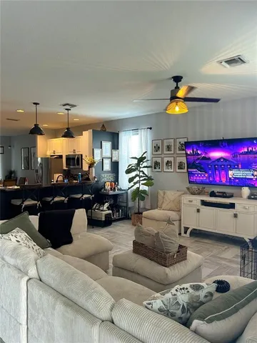 a view of a kitchen with a stove a refrigerator and a sink