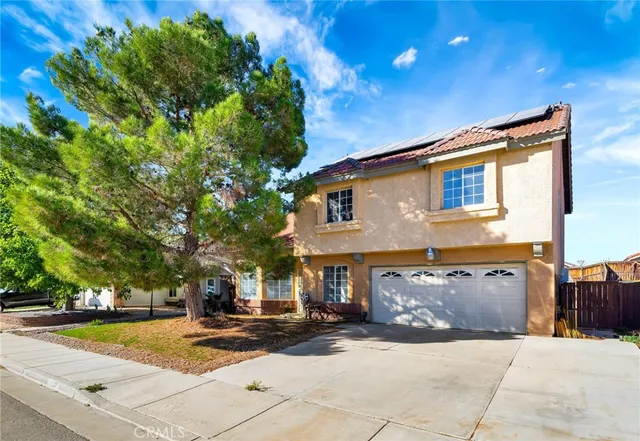a view of a house with a yard and garage