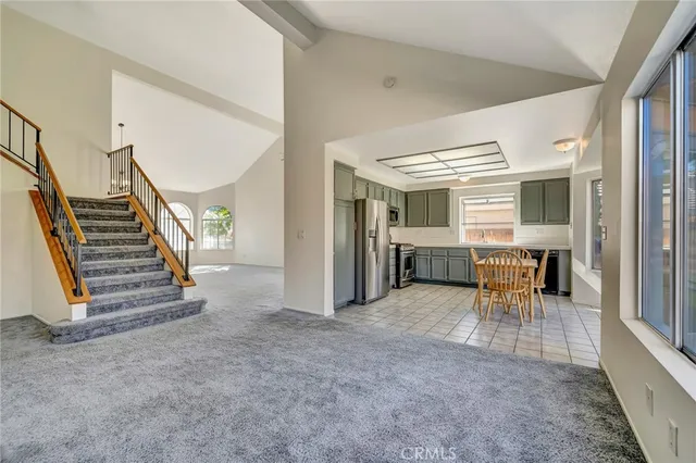 a view of a livingroom with furniture and stairs