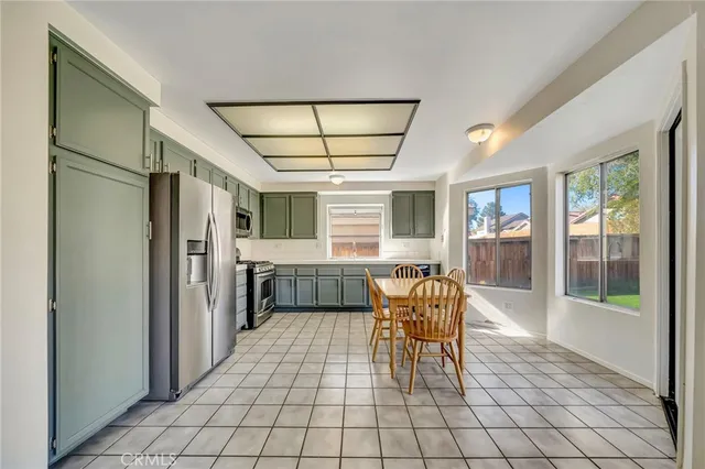 a view of a dining room with furniture a chandelier and wooden floor