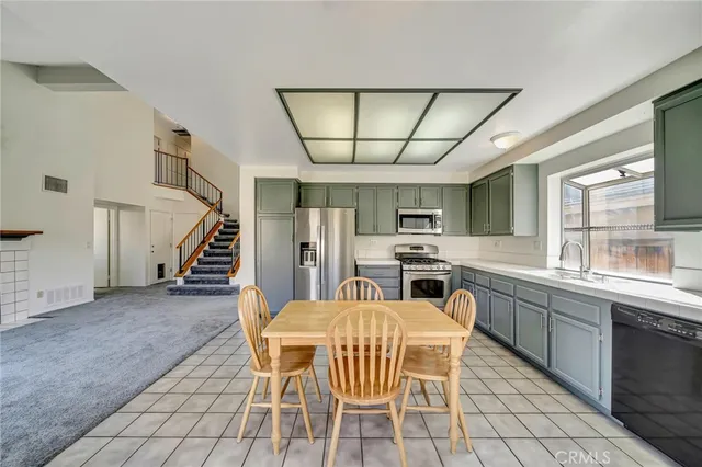 a kitchen with stainless steel appliances a refrigerator sink and microwave
