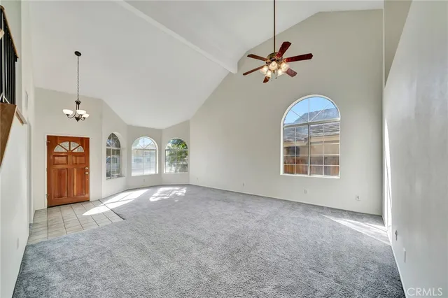 a view of a livingroom with a ceiling fan window and a chandelier