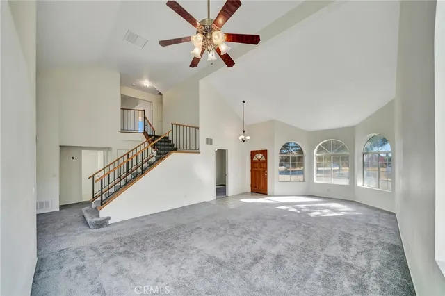 a view of empty room with ceiling fan