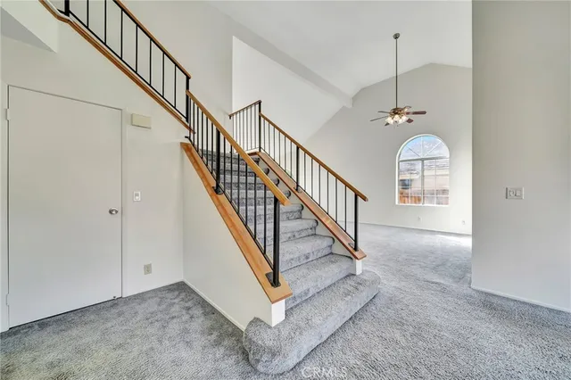 a view of staircase with railing and white walls
