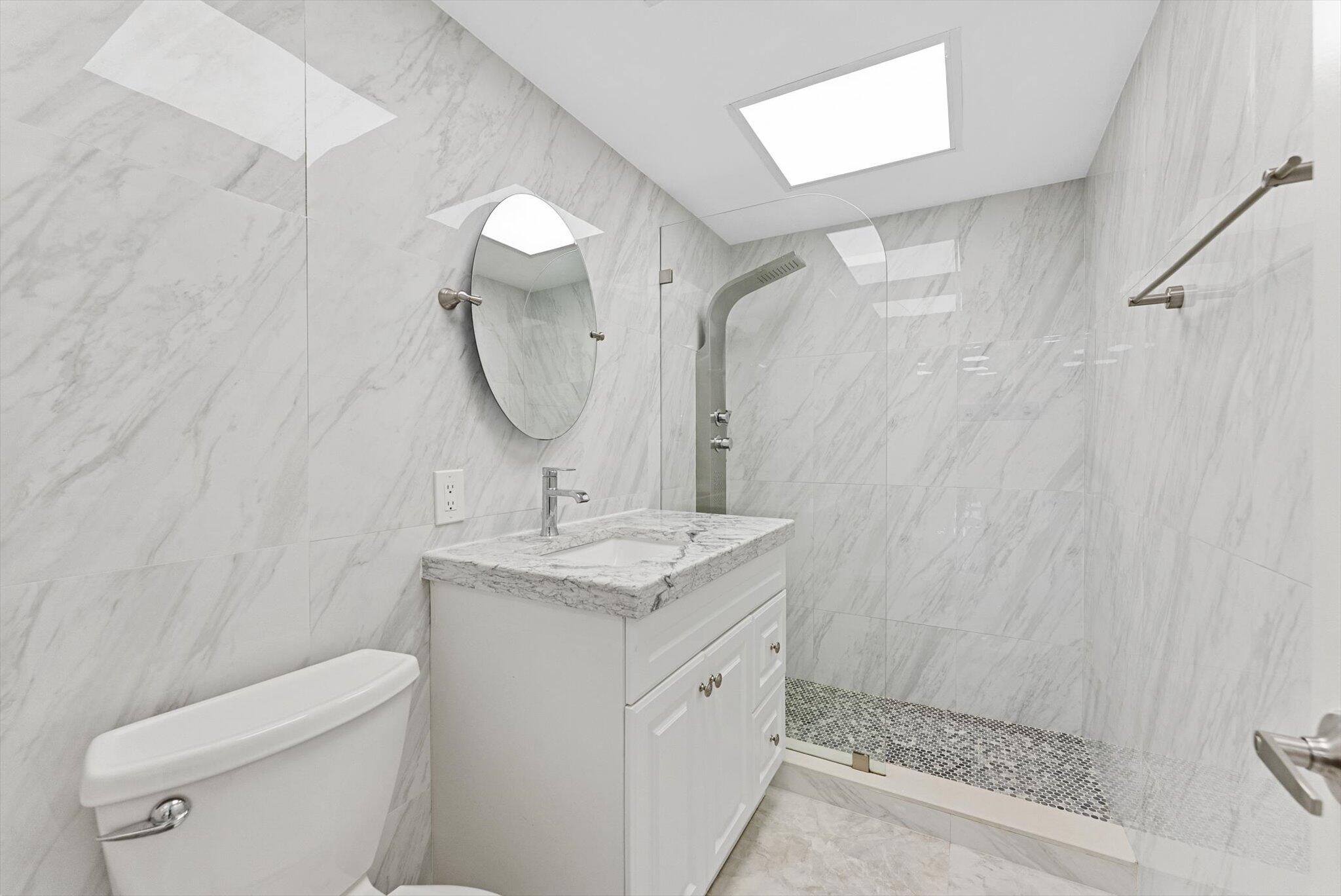 3730 Inverrary Drive, Unit 2L Lauderhill, FL 33319 - Photo 11 of 17 a bathroom with a granite countertop sink toilet and shower