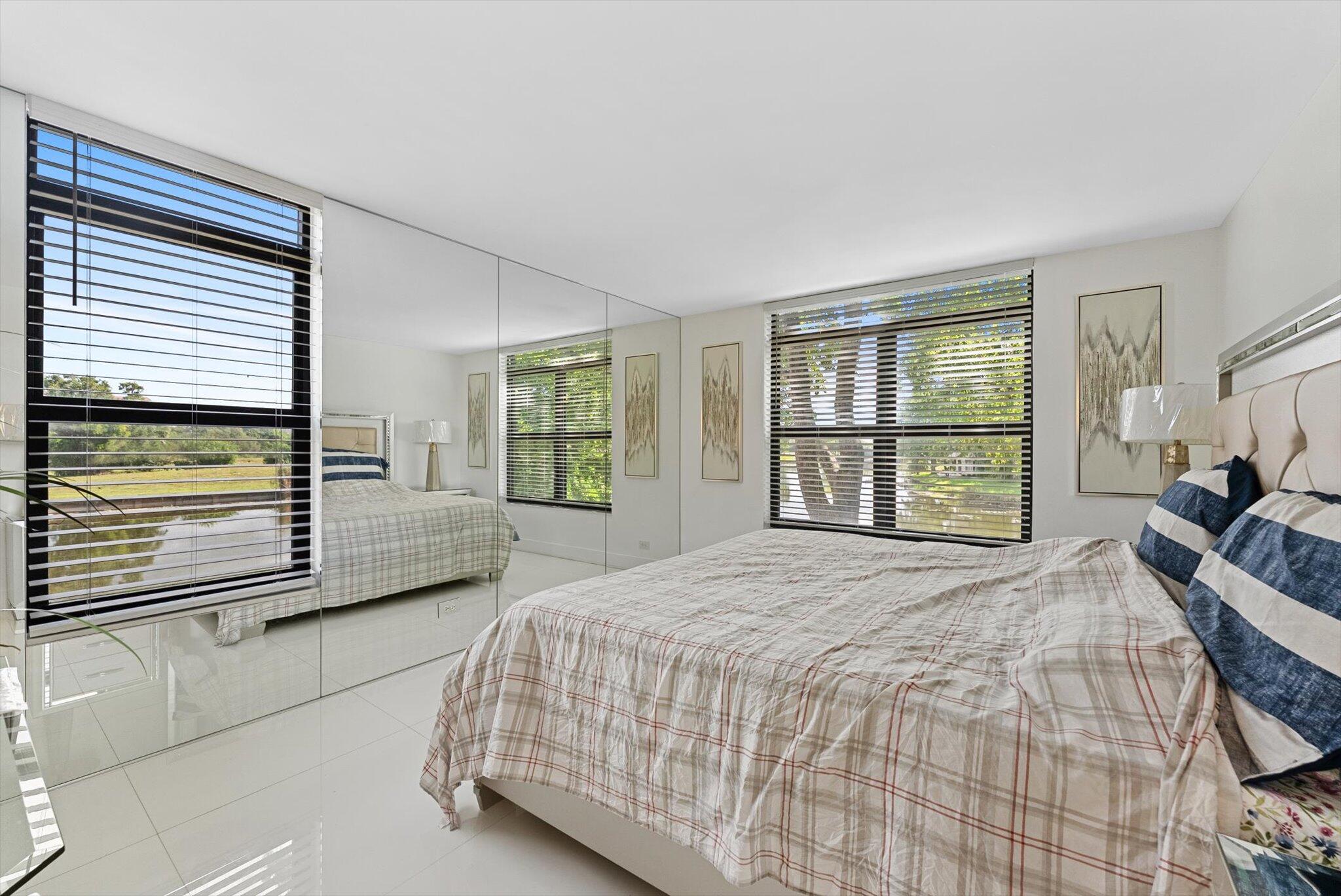 3730 Inverrary Drive, Unit 2L Lauderhill, FL 33319 - Photo 14 of 17 a spacious bedroom with a bed and a large window