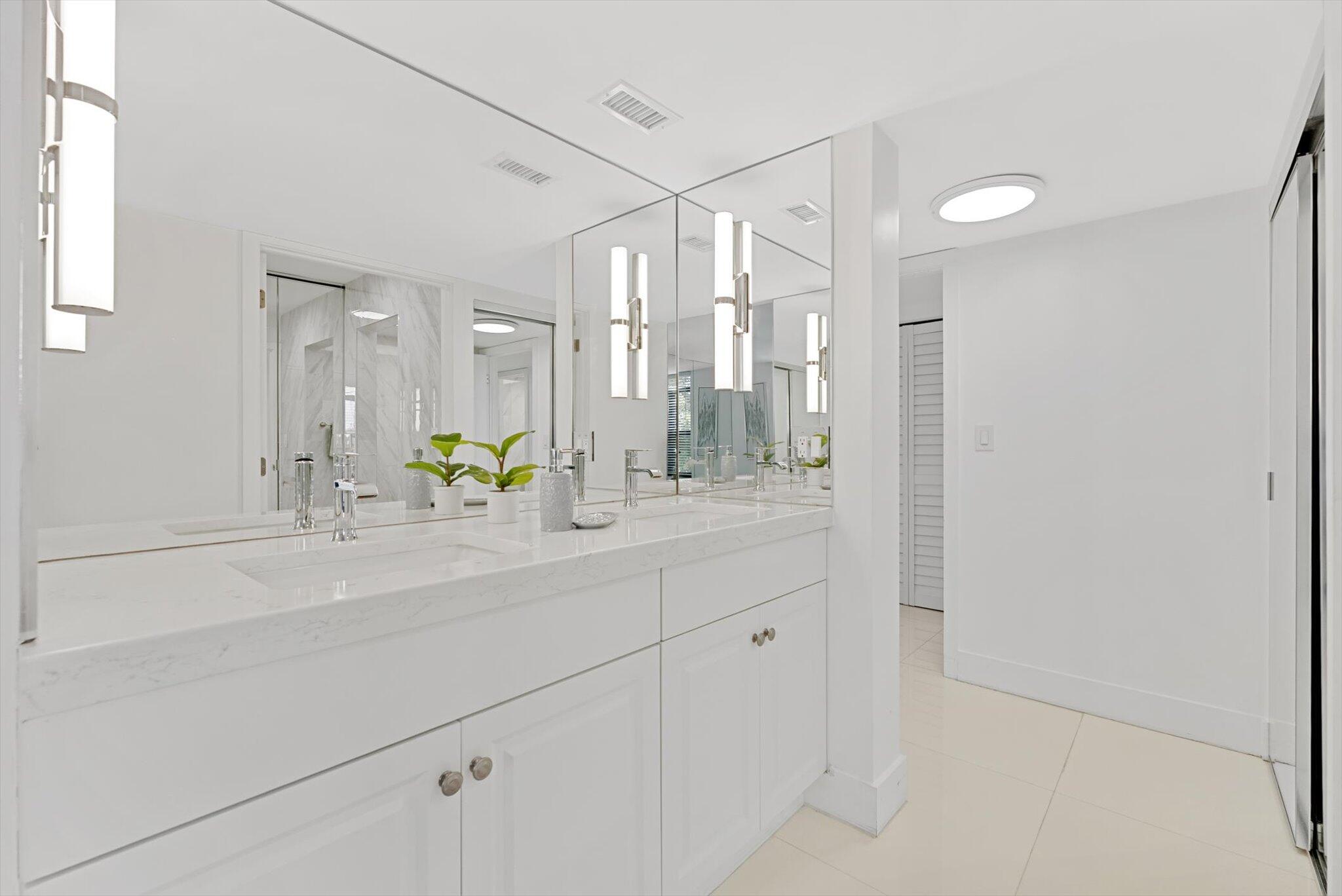 3730 Inverrary Drive, Unit 2L Lauderhill, FL 33319 - Photo 16 of 17 a bathroom with a sink a mirror and a shower