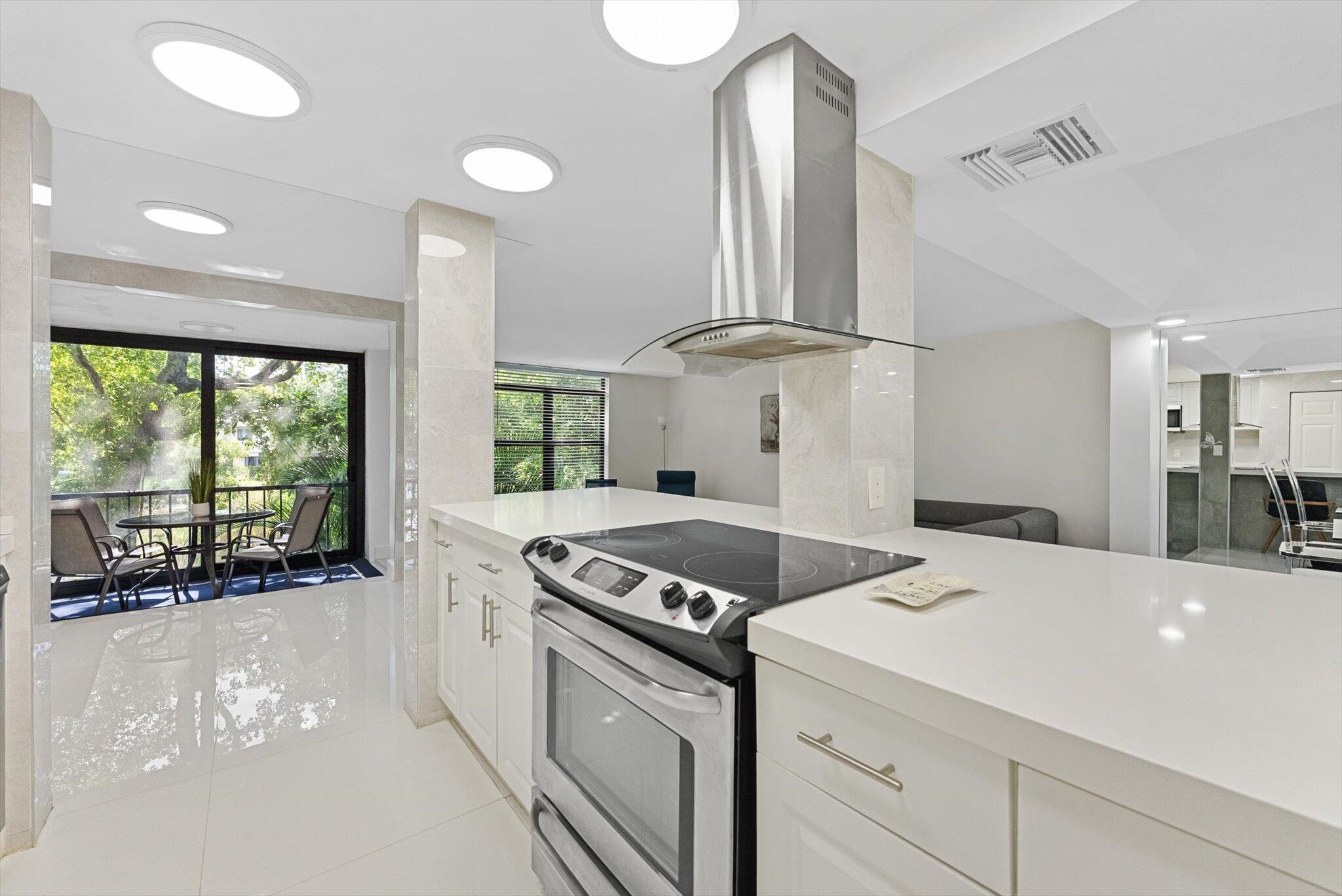 3730 Inverrary Drive, Unit 2L Lauderhill, FL 33319 - Photo 10 of 17 a kitchen that has a stove and a view of living room
