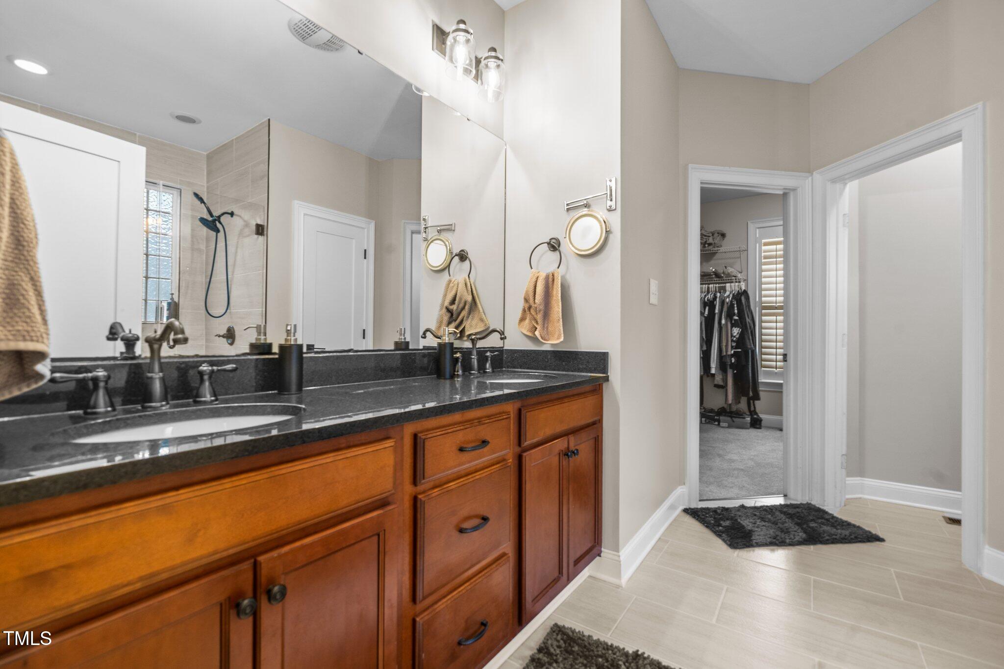 200 Heather Brook Circle Spring Lake, NC 28390 - Photo 11 of 36 a bathroom with a sink and a mirror