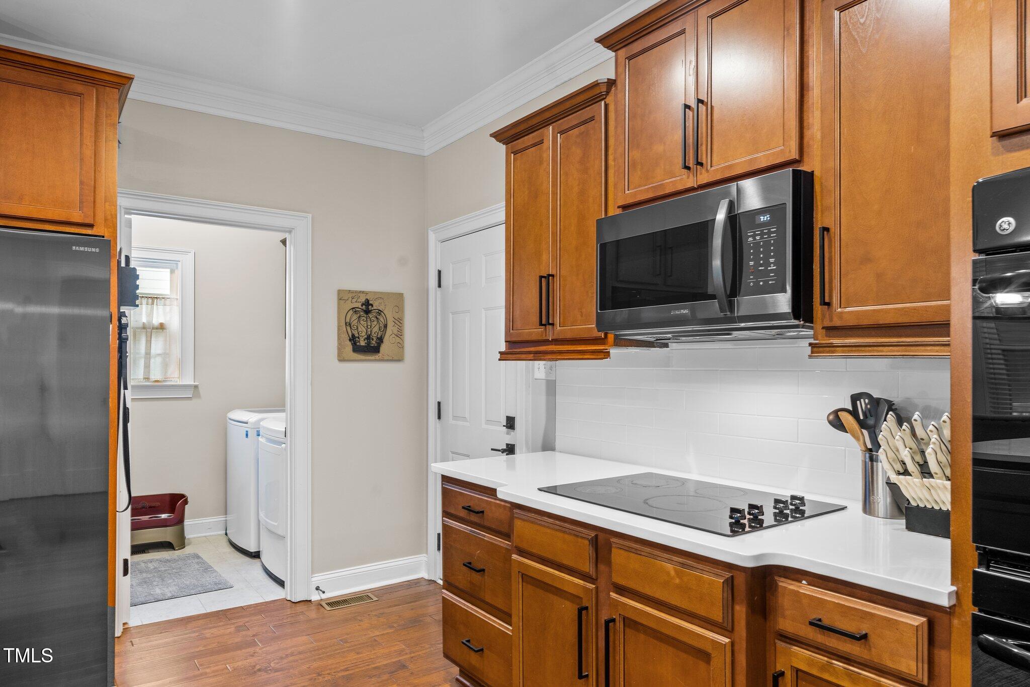 200 Heather Brook Circle Spring Lake, NC 28390 - Photo 15 of 36 a kitchen with stainless steel appliances granite countertop a sink a stove cabinets and wooden floor