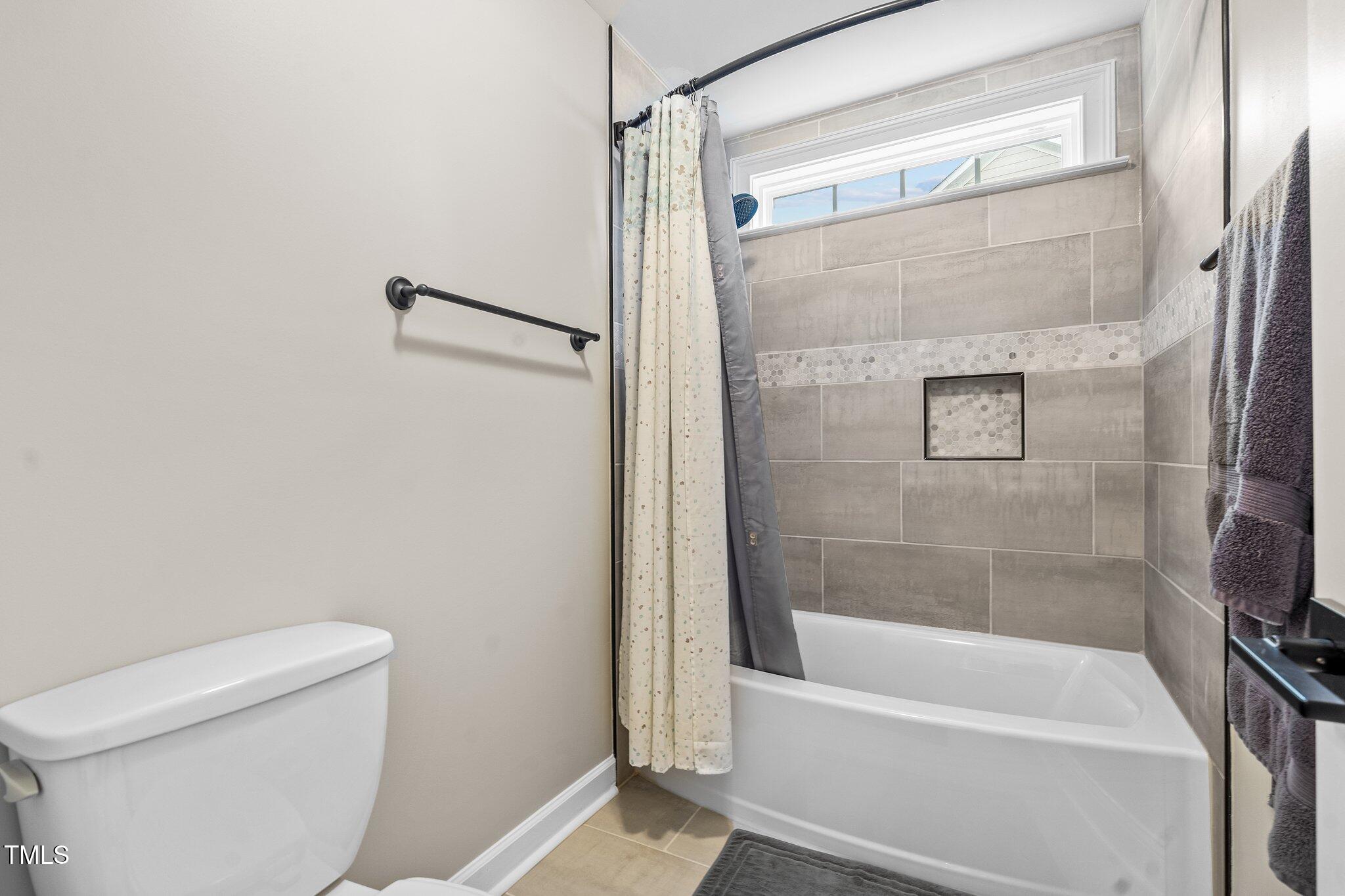 200 Heather Brook Circle Spring Lake, NC 28390 - Photo 19 of 36 a bathroom with a shower and a toilet