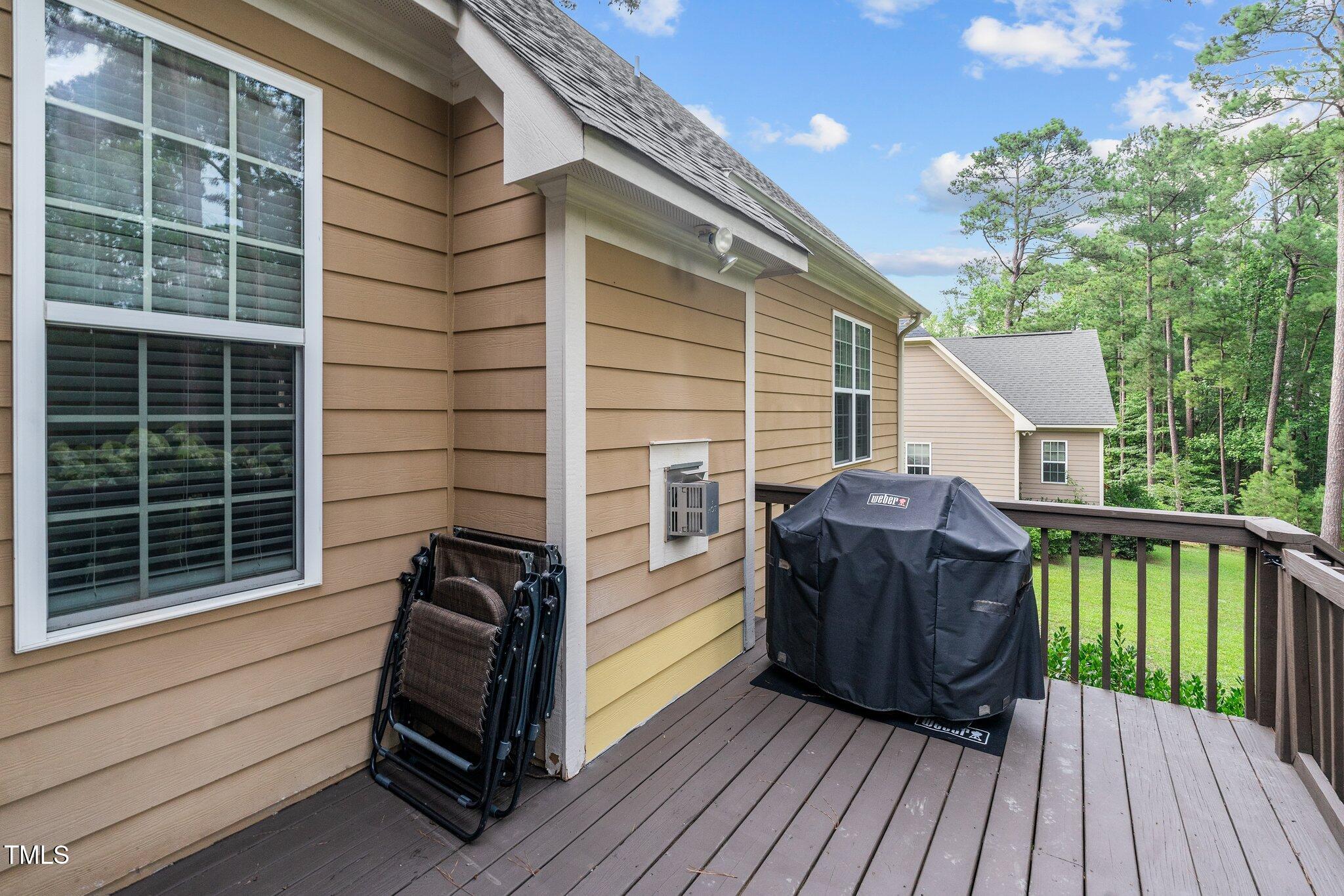 200 Heather Brook Circle Spring Lake, NC 28390 - Photo 28 of 36 a view of a deck with chairs and wooden floor