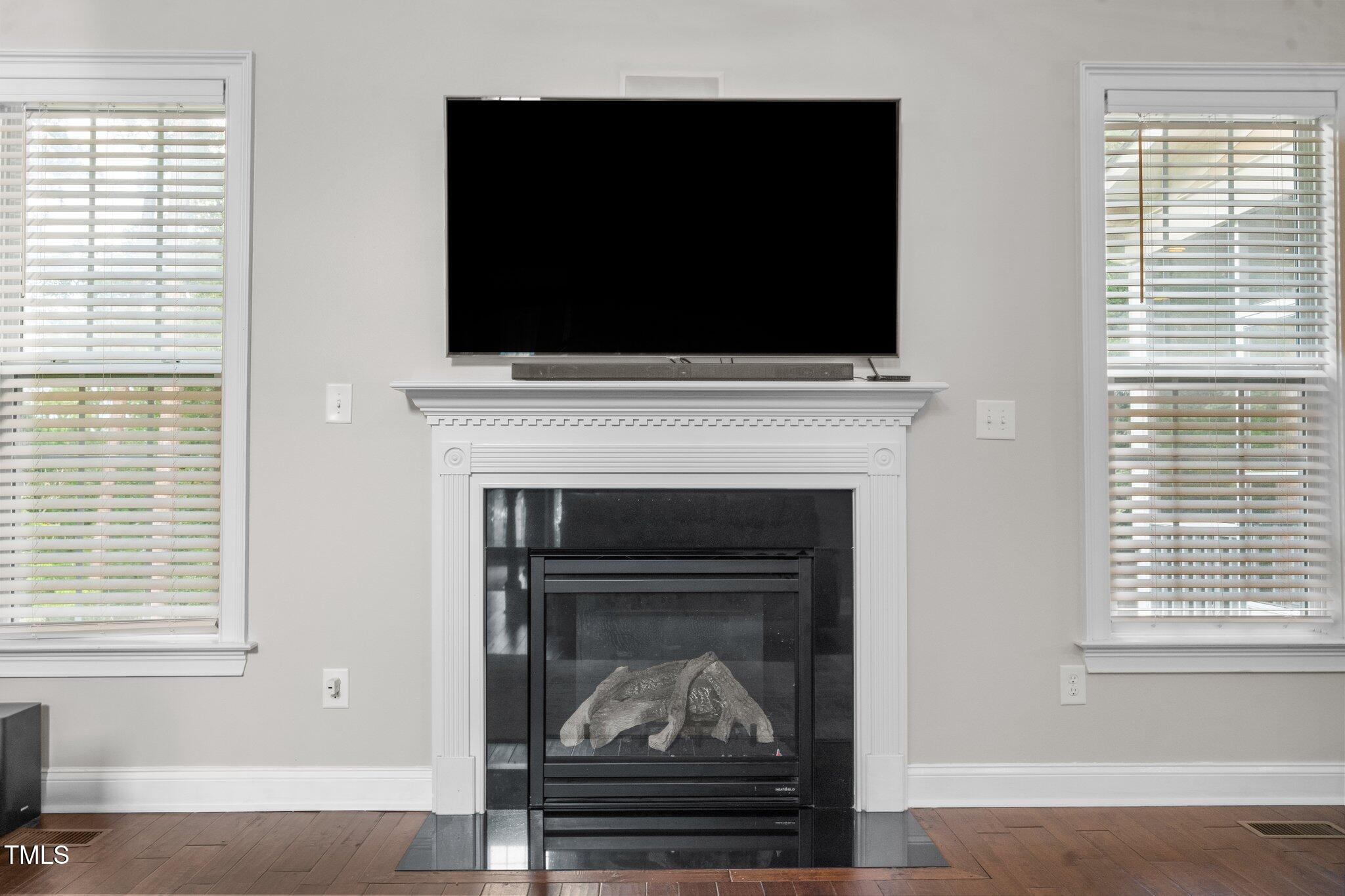 200 Heather Brook Circle Spring Lake, NC 28390 - Photo 4 of 36 a living room with a fireplace and a flat screen tv