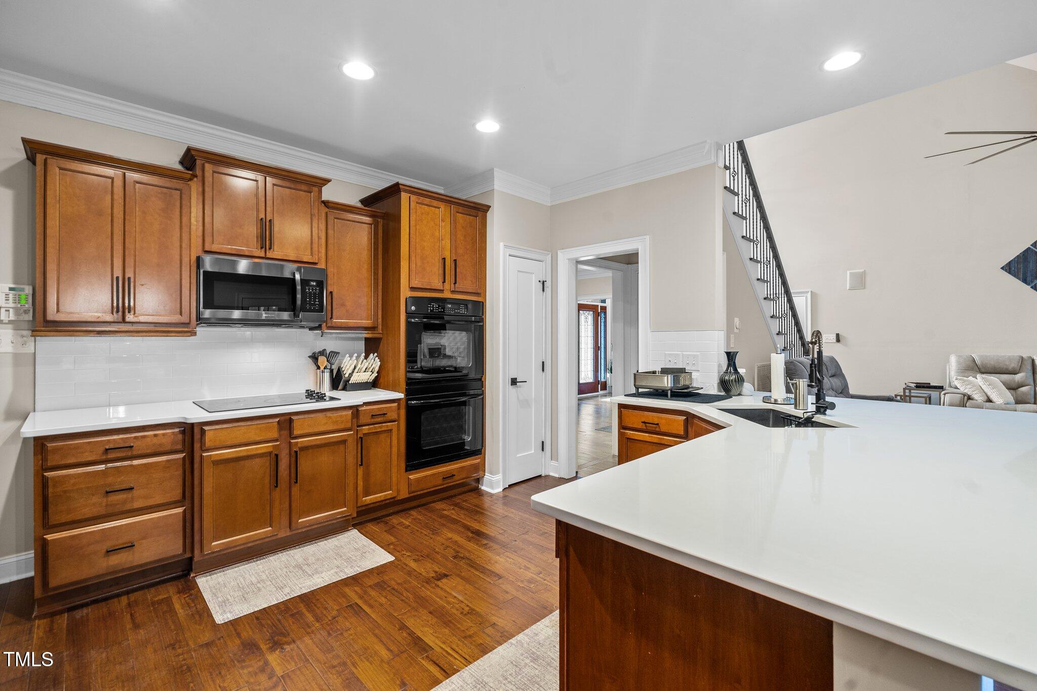 200 Heather Brook Circle Spring Lake, NC 28390 - Photo 6 of 36 a kitchen with stainless steel appliances kitchen island granite countertop a sink stove and refrigerator