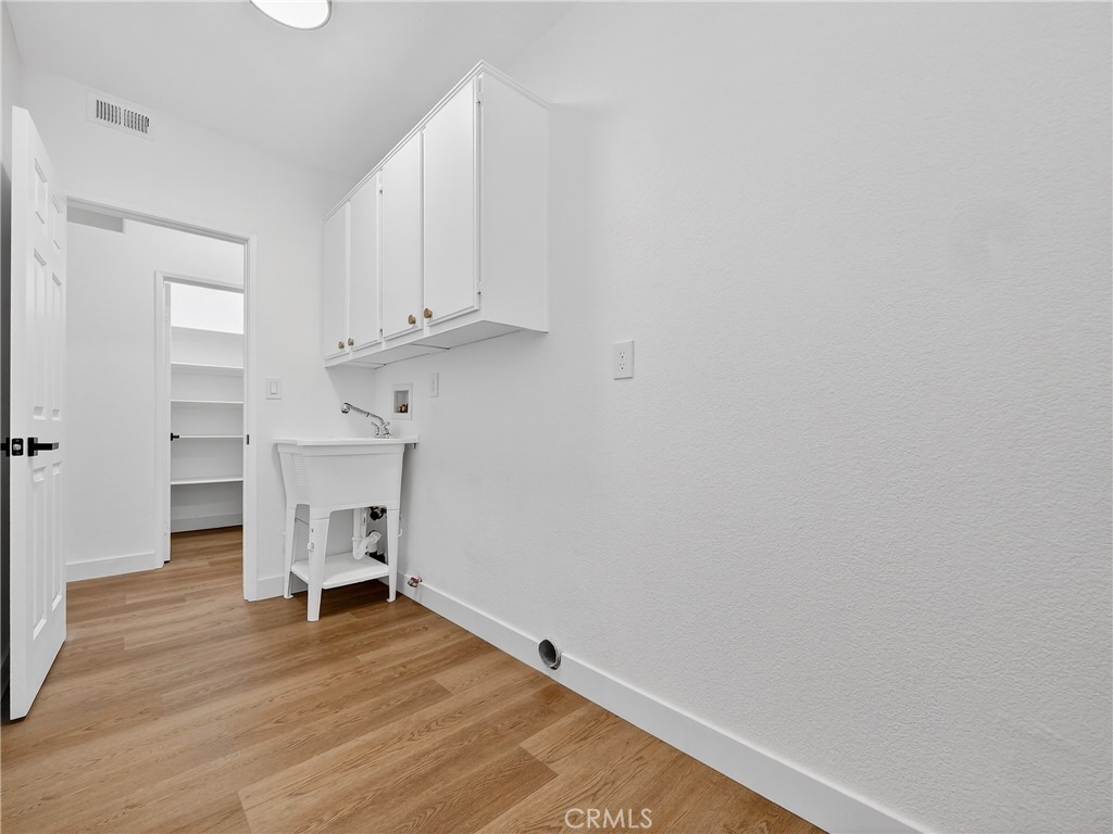 1436 Riviera Avenue Banning, CA 92220 - Photo 38 of 43 a view of empty room with wooden floor and cabinet