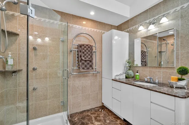 a bedroom with two beds and a desk