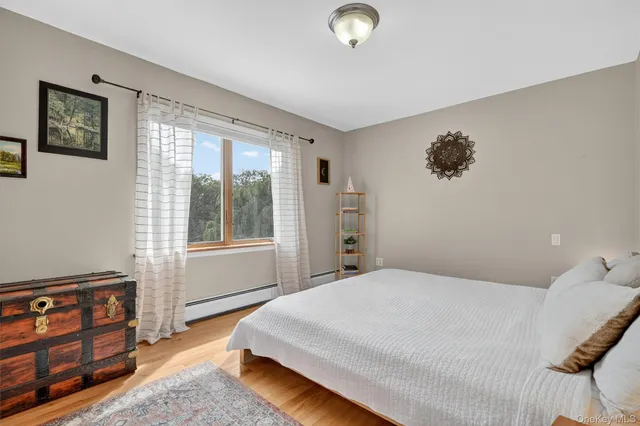 a bedroom with a large bed and a window