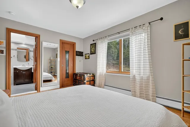 a living room with furniture a table and bookshelf
