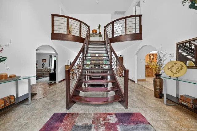 a view of entryway and hall with wooden floor