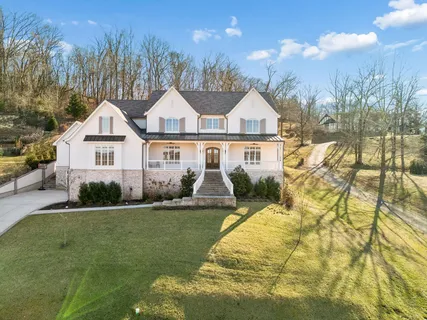 a living room with furniture a table and a large window
