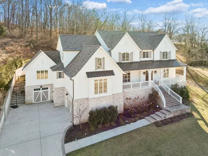 a view of a dining room with furniture a chandelier and wooden floor