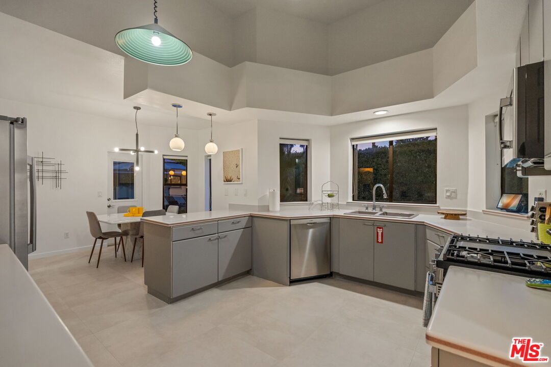 1414 Sagebrush Road Palm Springs, CA 92264 - Photo 21 of 48 a large kitchen with a table and chairs in it