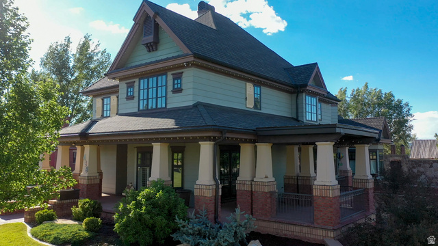 426 West Center Street Parowan, UT 84761 - Photo 6 of 107 Two-story residence featuring a covered front porch with substantial columns, brick accents, and a dark railing