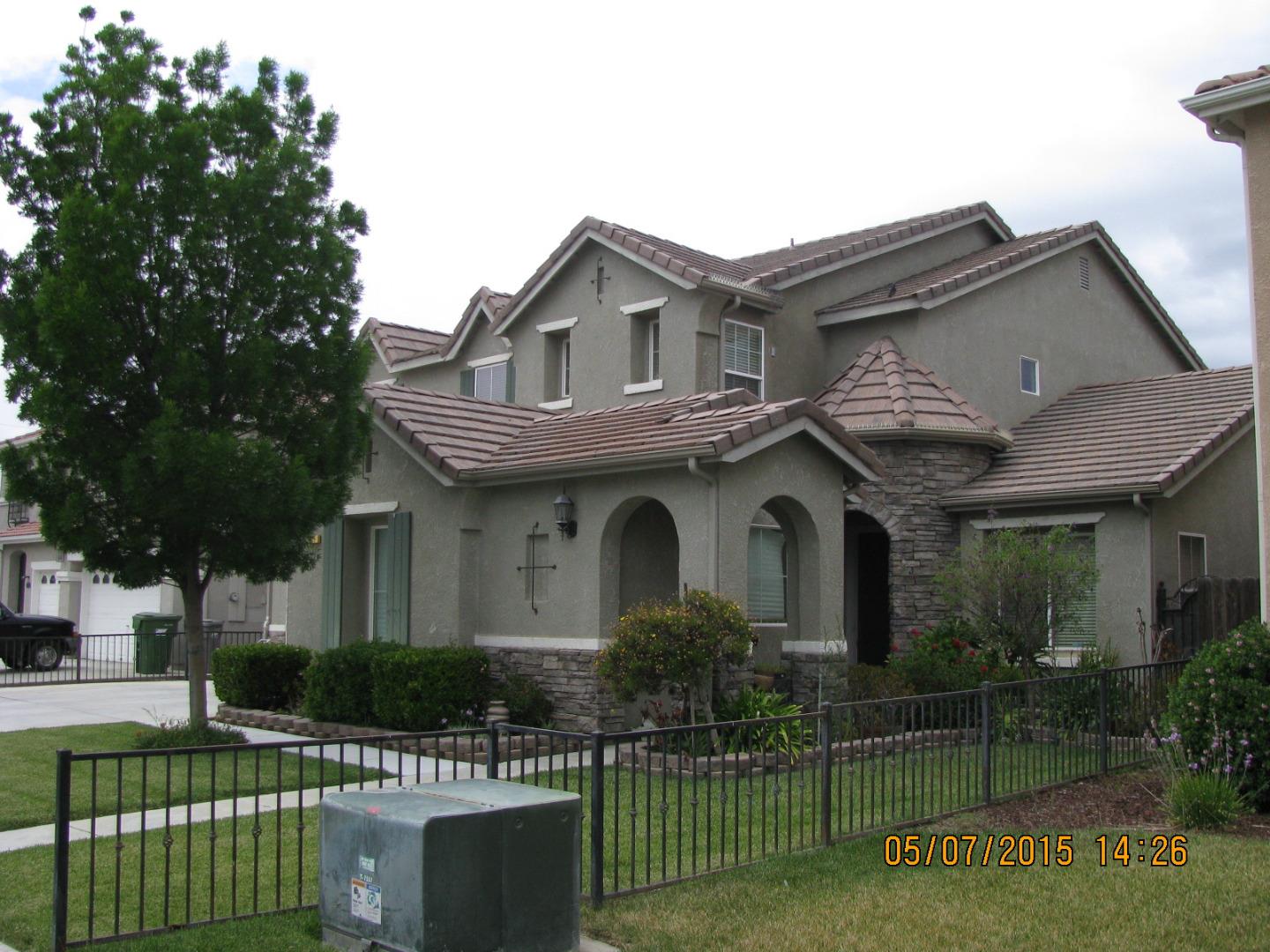 911 Azalea Court Los Banos, CA 93635 - Photo 2 of 5 a front view of a house with a garden