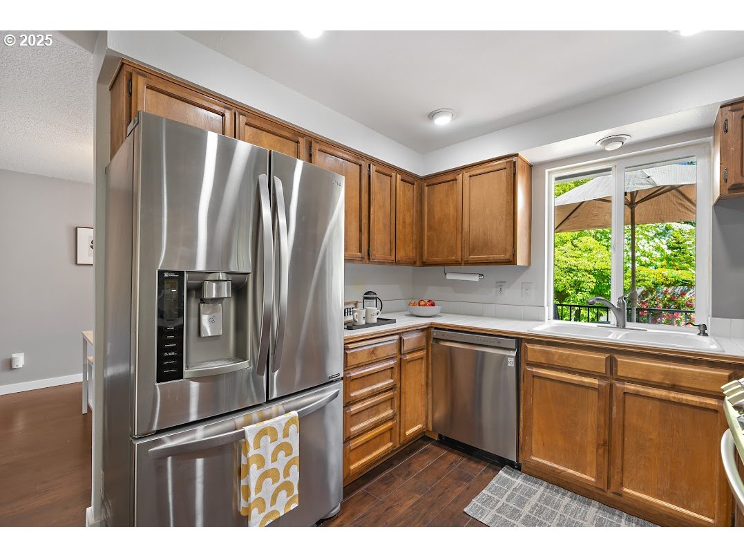 11595 Southwest Fairview Lane Tigard, OR 97223 - Photo 13 of 46 a kitchen with stainless steel appliances granite countertop a refrigerator and a sink