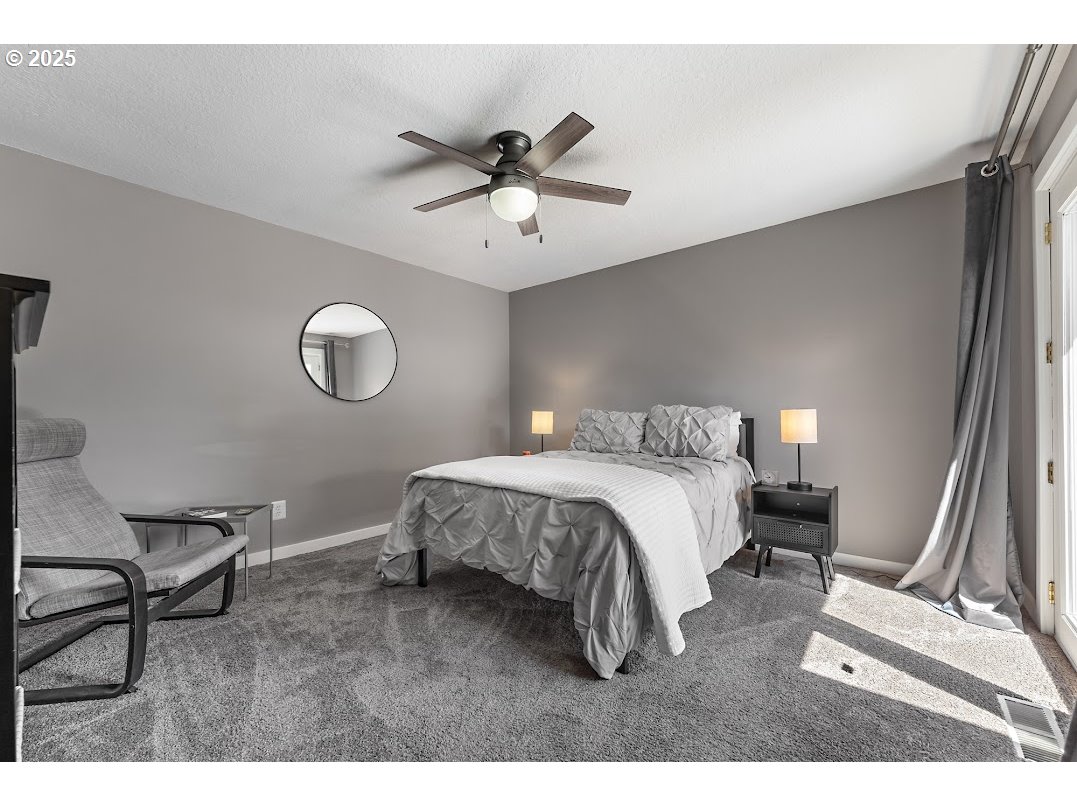 11595 Southwest Fairview Lane Tigard, OR 97223 - Photo 21 of 46 a bedroom with a bed and a chandelier