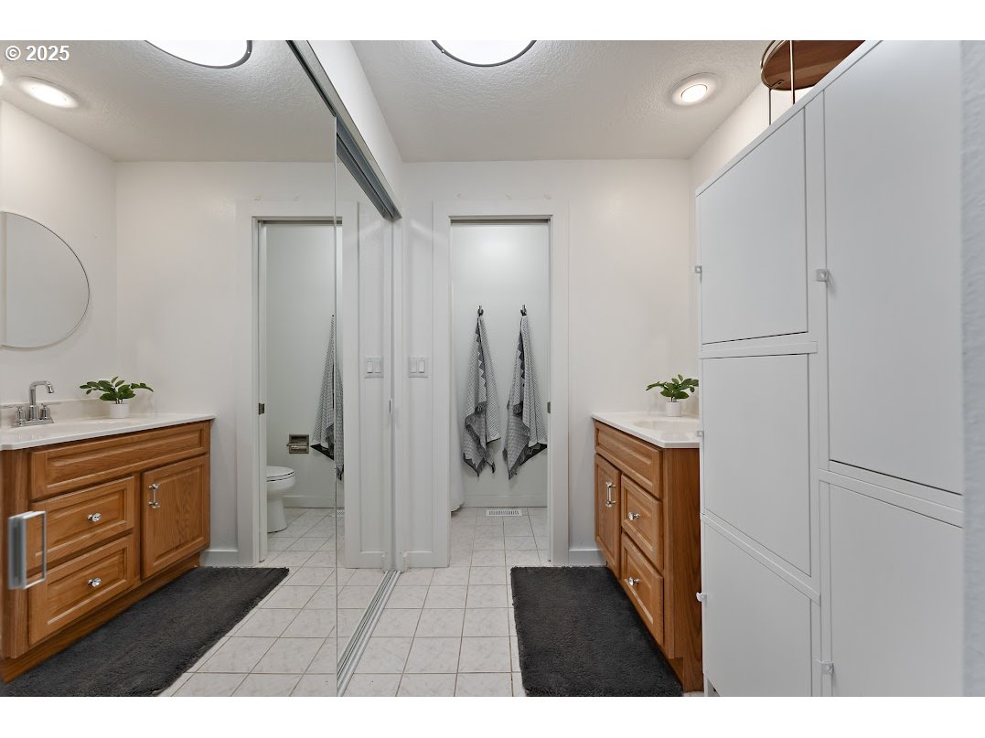 11595 Southwest Fairview Lane Tigard, OR 97223 - Photo 25 of 46 a bathroom with a granite countertop sink a mirror and shower