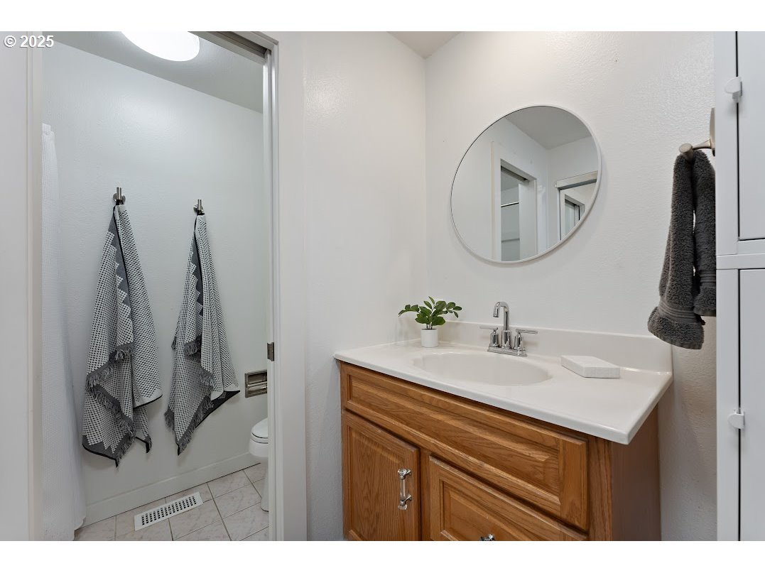 11595 Southwest Fairview Lane Tigard, OR 97223 - Photo 26 of 46 a bathroom with a sink vanity and a mirror