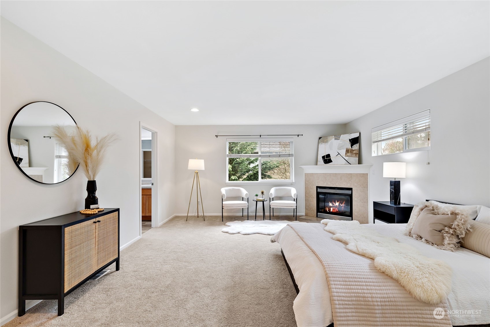1700 235th Place Southwest Bothell, WA 98021 - Photo 28 of 36 a spacious bedroom with a large bed and a fireplace