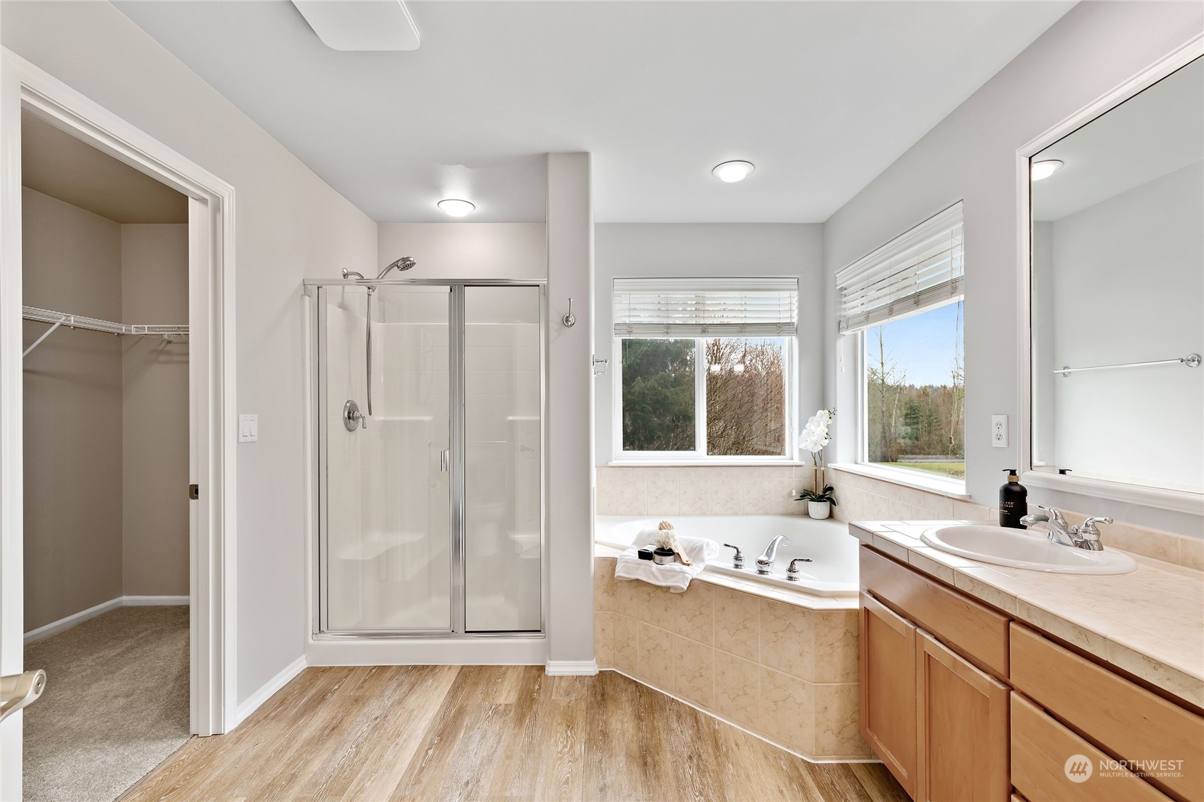 1700 235th Place Southwest Bothell, WA 98021 - Photo 31 of 36 a spacious bathroom with a double vanity sink a large mirror and a bathtub